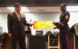 Tachi Palace Assistant General Manager Bill Davis presented a $3,500 check to Staff Sargeant Holmes for the Toys for Tots program.